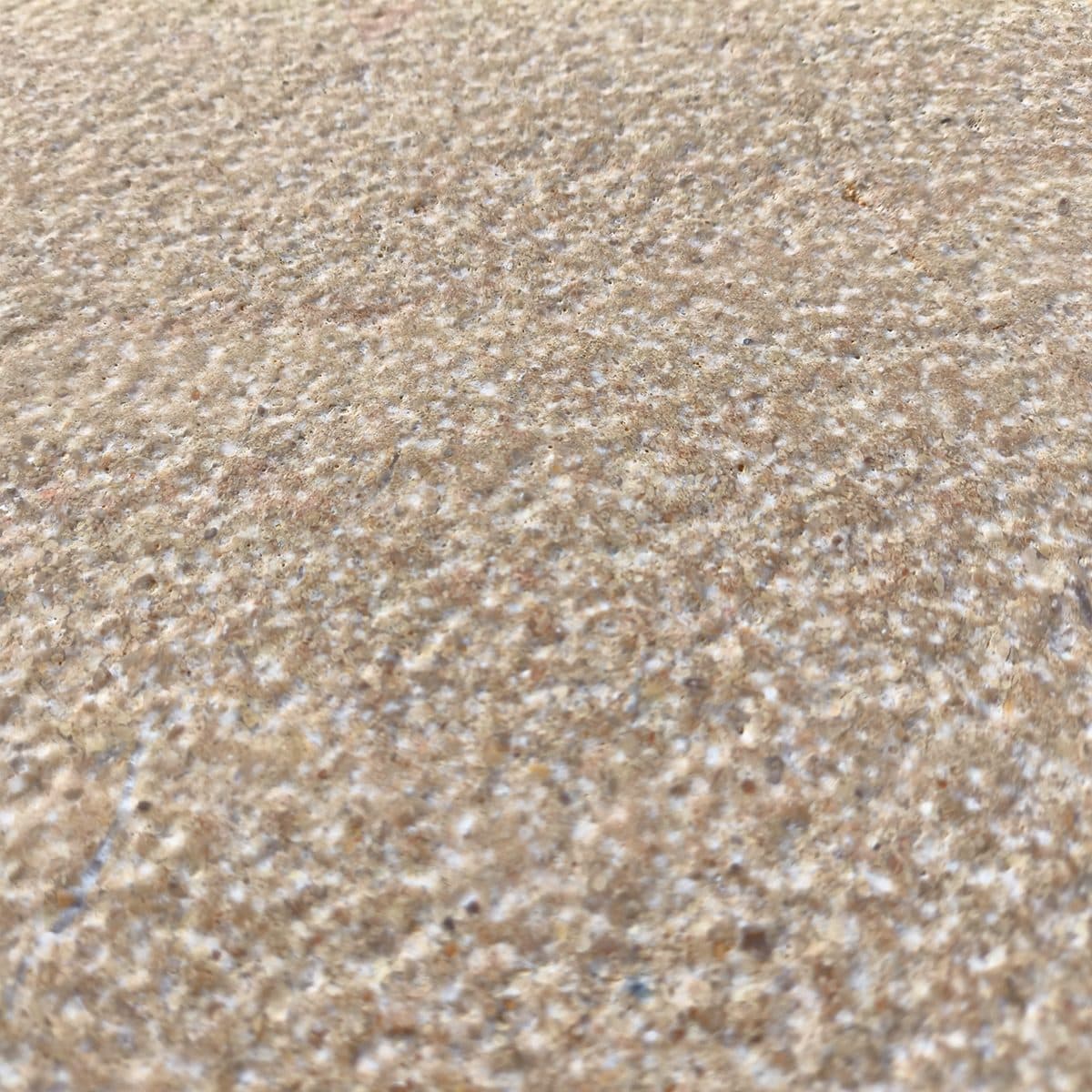 Bush-hammered travertine texture in shallow focus